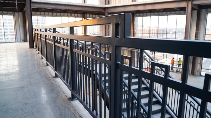 Custom steel access railing and staircase fabricated by DavFab installed in a commercial building under construction